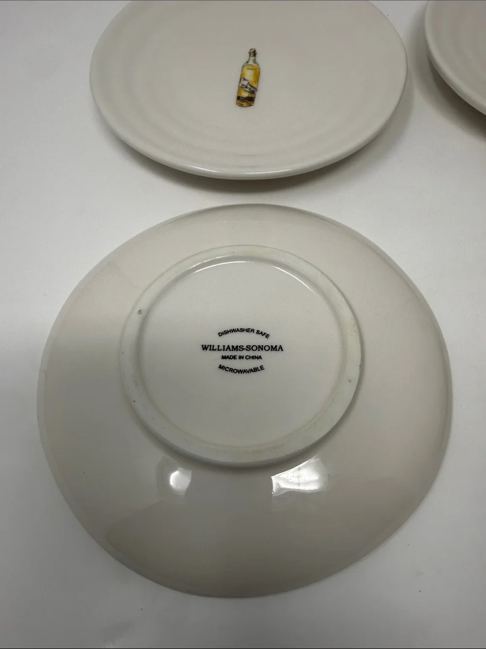 Williams Sonoma Cream Ceramic Dinner Plates with Wine Bottle Motifs - Set of 4